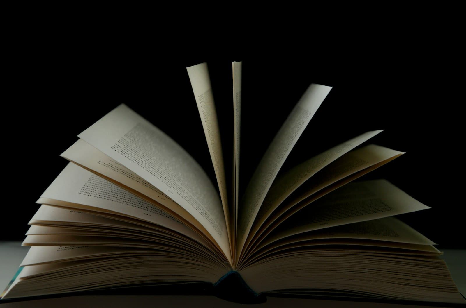 Open bound volume on a dark background