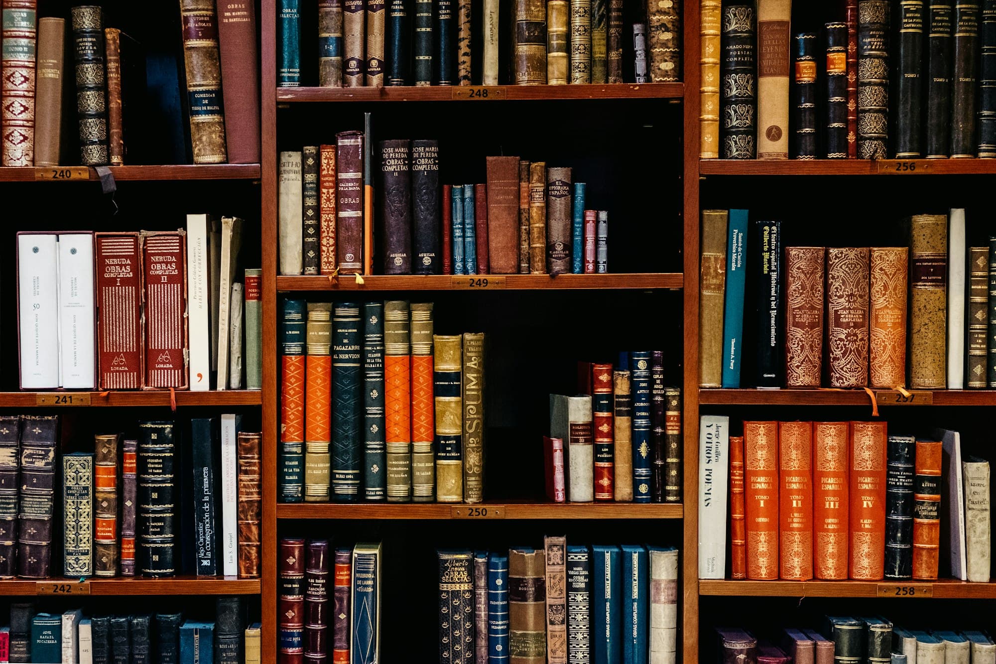 Bound legal volumes arranged on dark wooden library shelves