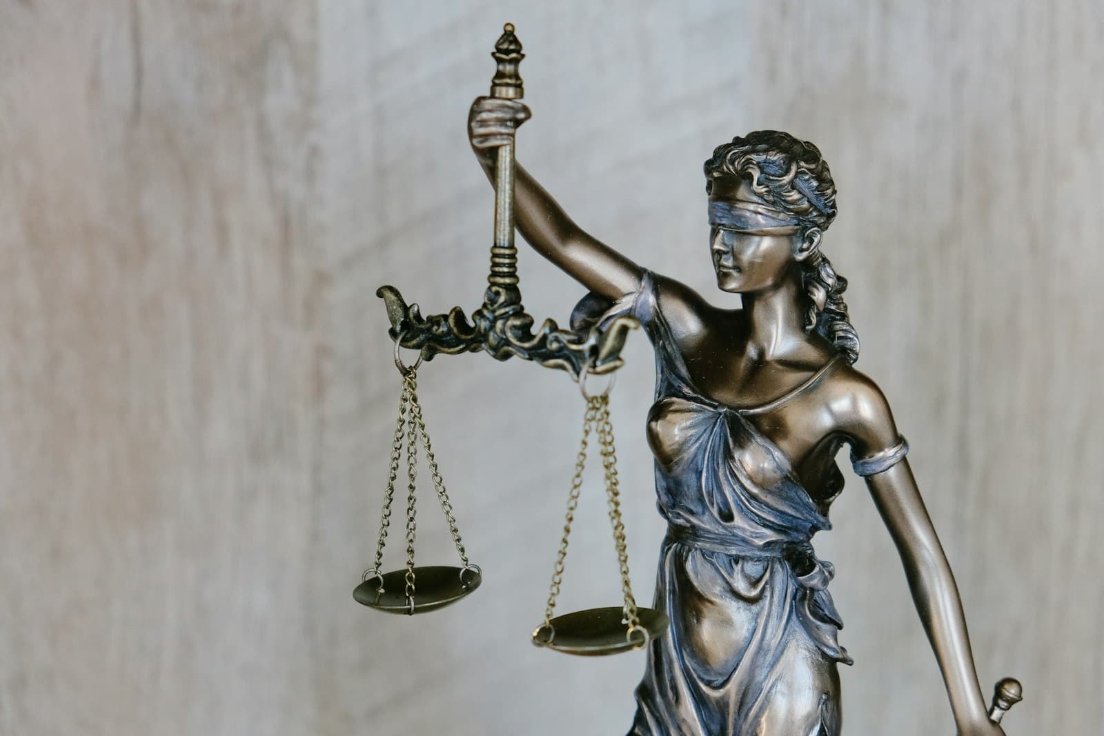 Bronze statue of Justice holding scales and a sword